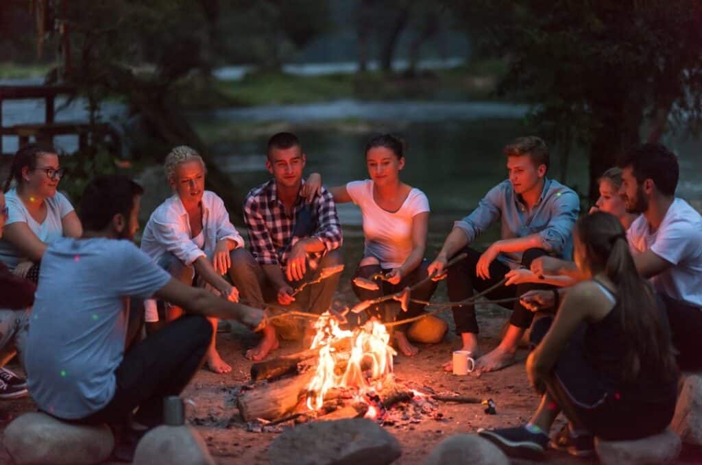adults around a camp fire