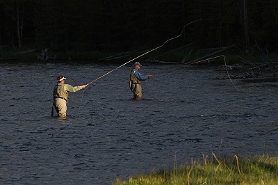 Anglers fly fishing on river