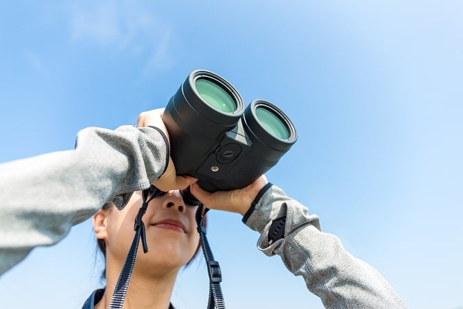 girl with compact zoom binoculars