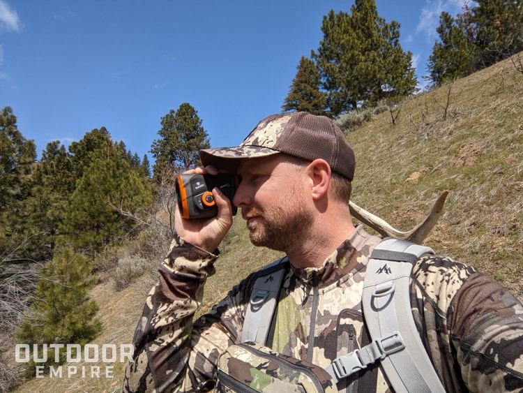 Hunter in camo using rangefinder
