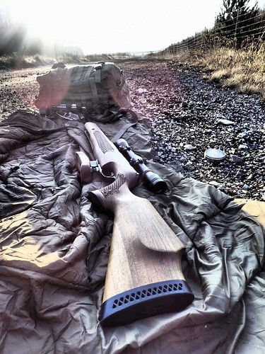 Rifle on cloth laying on the ground