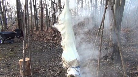 Smoking deer hide in the woods