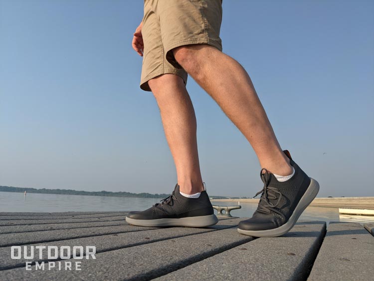 Man's legs walking on a boat dock
